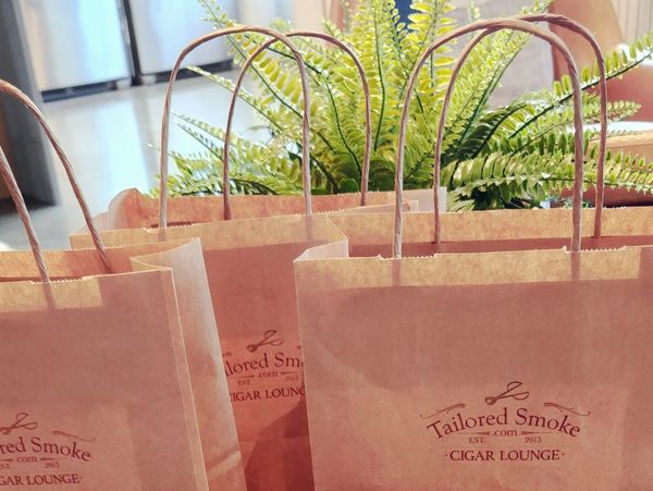 Merchandise bags stamped with the Tailored Smoke logo
