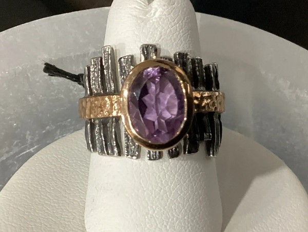 Oxidized sterling silver ring with bronze accents and a faceted amethyst gemstone centerpiece.