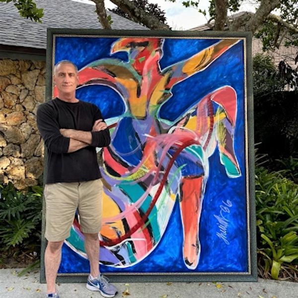 A photo of the artist Keith Theriot standing next to one of his paintings