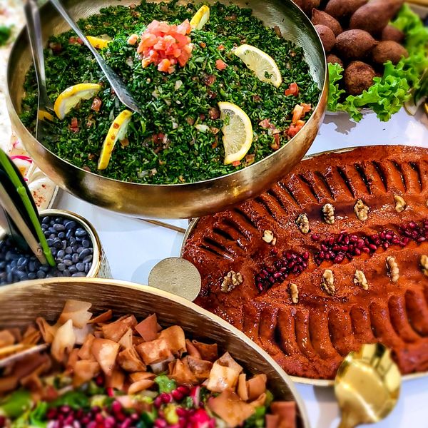Tabouleh, Muhammara, and Fattoush in gold plates buffet setup