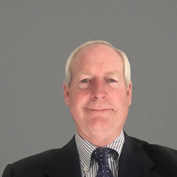 Middle-aged man in a suit and tie with a neutral expression.