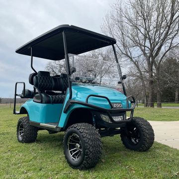A Custom Teal 2017 EZGO TXT with teal paint, a 3in drop spindle lift, and custom diamond stich seats
