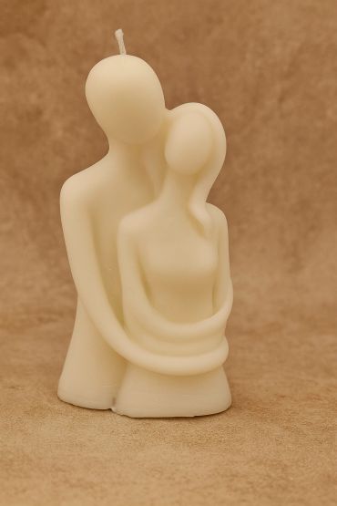 A couple-shaped candle embracing each other.