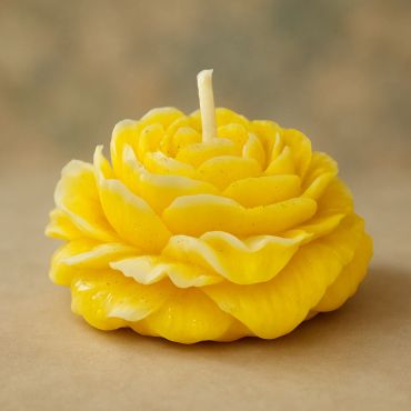 Yellow flower-shaped candle.
