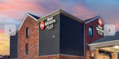 Exterior of Best Western Plus hotel during sunset.