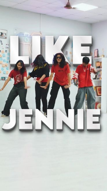 Four people dancing indoors with large text 'LIKE JENNIE' overlaying the image.