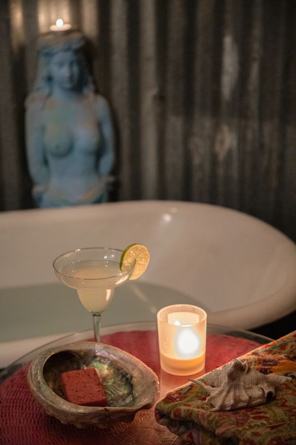 Margarita next to bathtub with candle