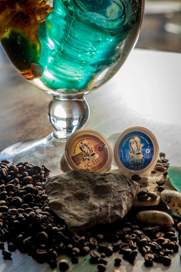 CBD kcups with coffee beans and rocks