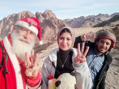 Young Doctor, Arab friend and SustainaClaus in desert near st Catherine, Mount Sinai, Egypt
