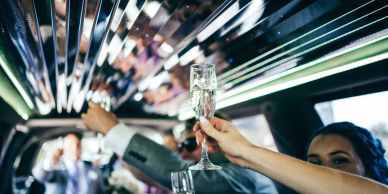 People clinking glasses in a limousine.