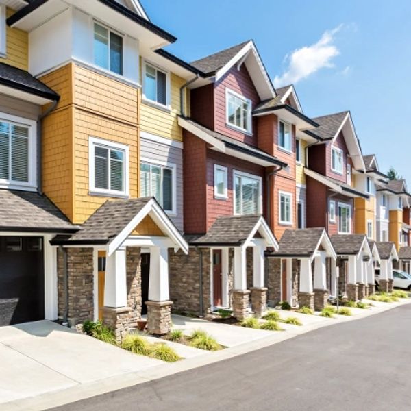 Row of colorful modern townhouses on a sunny day.