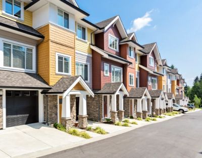 Row of modern townhouses with colorful exteriors.