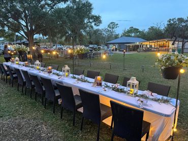 Candlelit tables set up in a pasture for a special Farm to Table dinner event.
