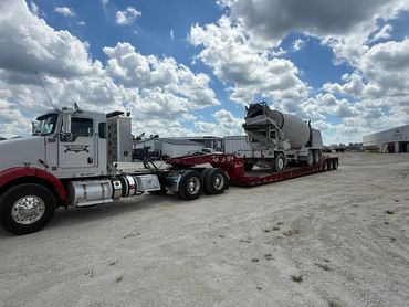 Maximum Towing heavy-duty semi hauling concrete mixer on 50-ton lowboy trailer in Central Florida