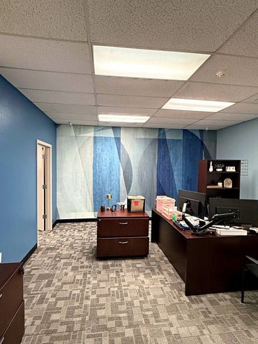 Blue abstract wall mural behind an executive desk in a commercial office in Arizona