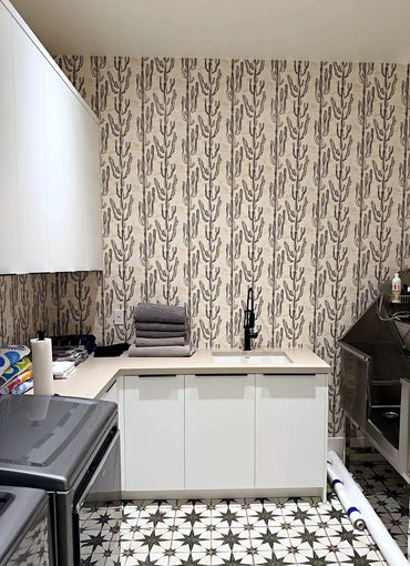 Black-and-white cactus print wallpaper in a bright laundry room with star tile floor in Arizona