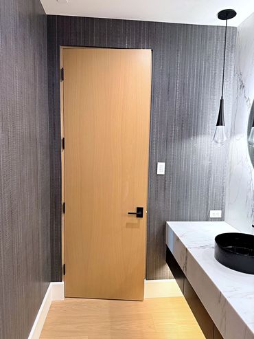 Charcoal custom acrylic wallcovering in a powder room with floating marble vanity and pendant light