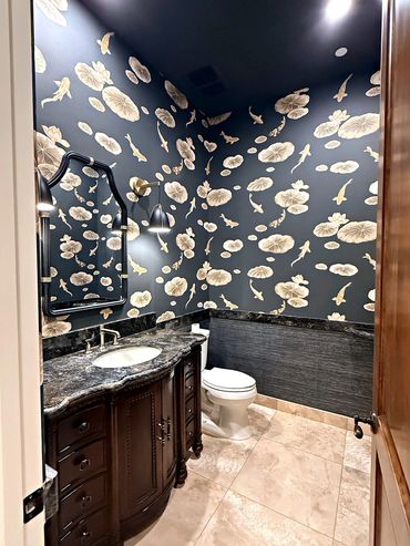 Koi lily pad mural above a navy grasscloth wainscot behind a dark vanity and mirror in an Arizona po