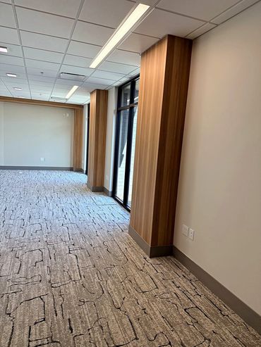 Wood-look wallcovering column wraps along a commercial office corridor in Arizona