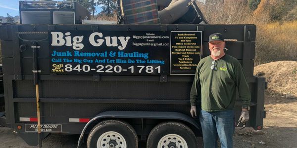 Big Guy Junk Removal trailer and owner on job site in Crestline CA.