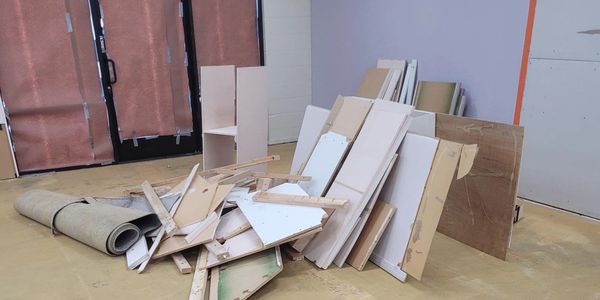 alt="Construction debris cleanup with drywall and wood materials ready for removal"Crestline,CA