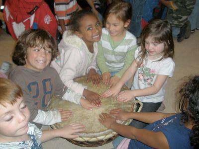 children drumming altogether