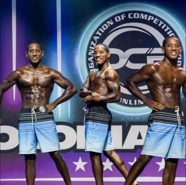Three muscular men posing in a bodybuilding competition.