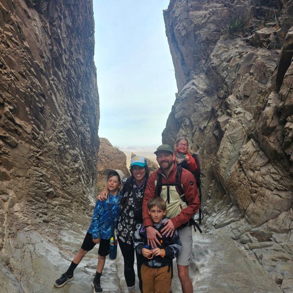 Family hiking through a narrow canyon.
