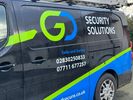 A security solutions van with contact numbers displayed.