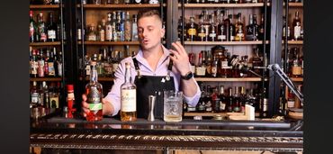 Giambrone, the host of pouring stories, is on set making a cocktail with Alpine Distilling's brands.