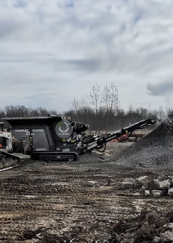 Industrial KOMPLETT K-JC704 machine processing gravel outdoors.