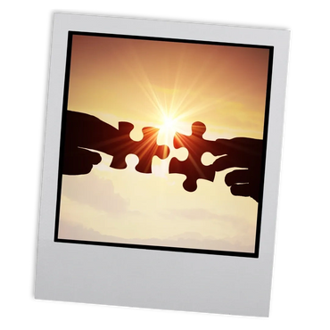 A small Polaroid image of two jigsaw pieces coming together with the sun setting behind them.