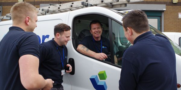 Operatives talking near Laker van