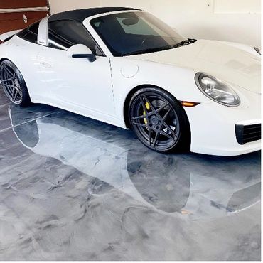 White convertible sports car parked on a shiny, marbled floor.