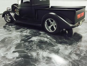 Matte black classic pickup truck with chrome wheels and "THE END" in red on the tailgate.