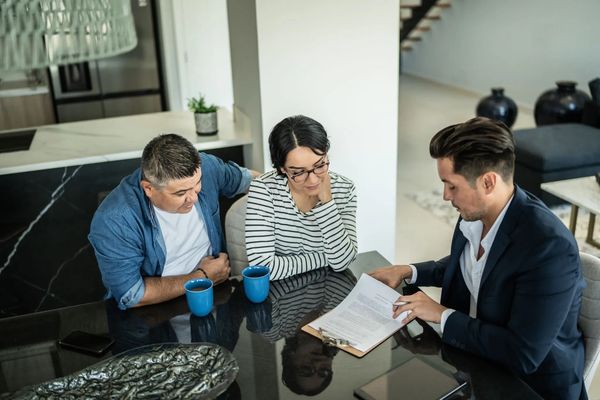 Couple signing papers with a professional