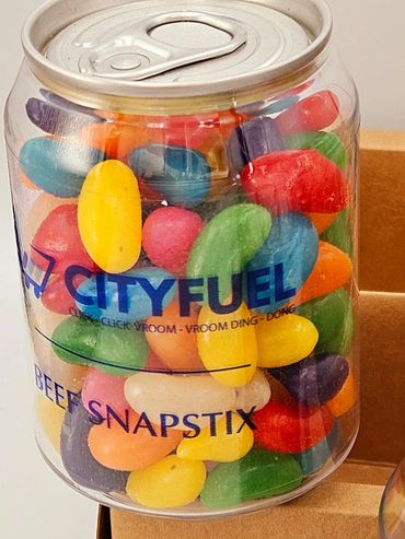 A clear can-shaped container filled with colorful jelly beans.