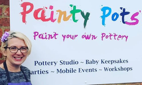 Eva standing with Painty Pots sign.