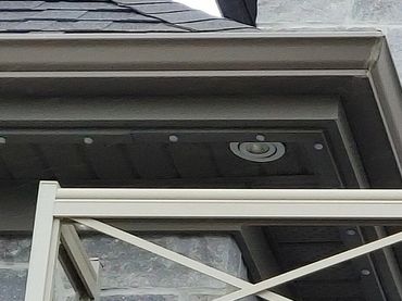 Modern home entrance with stone facade and blue double doors.