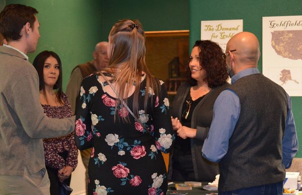 Sarah Paige Medium chats with people at a group reading event in Colorado.