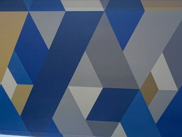 Roller blind with geometric blue, gray, and beige pattern.