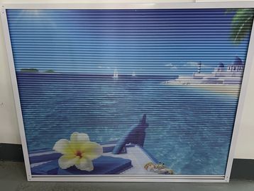 Scenic seaside view from a boat with a flower and distant buildings.