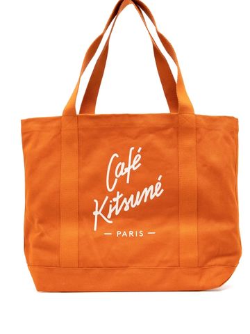 Orange tote bag with Café Kitsuné Paris logo.