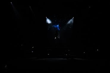 Denise Moyo, poet, singer and songwriter who was born in Zimbabwe getting ready to sing on stage.