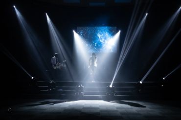 Denise Moyo, poet, singer and songwriter who was born in Zimbabwe singing on stage.