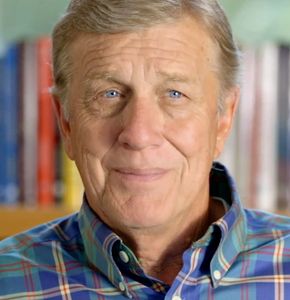 Portrait of an elderly man with blue eyes and a plaid shirt.