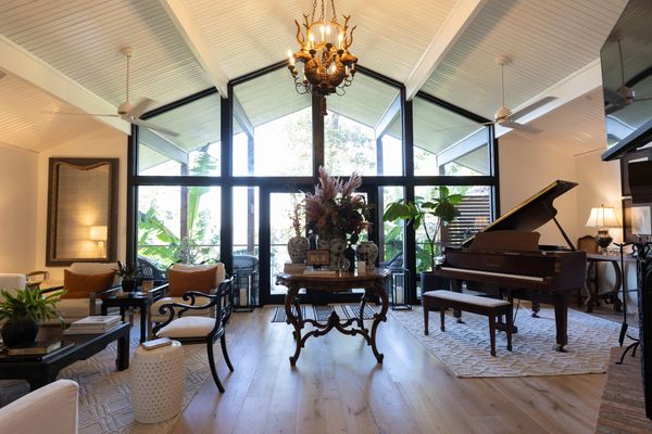 The large family room's expansive glass affords wonderful views of the lake and its surrounding cypr