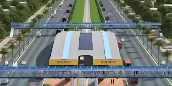 Modern station on a busy road with pedestrian bridges.