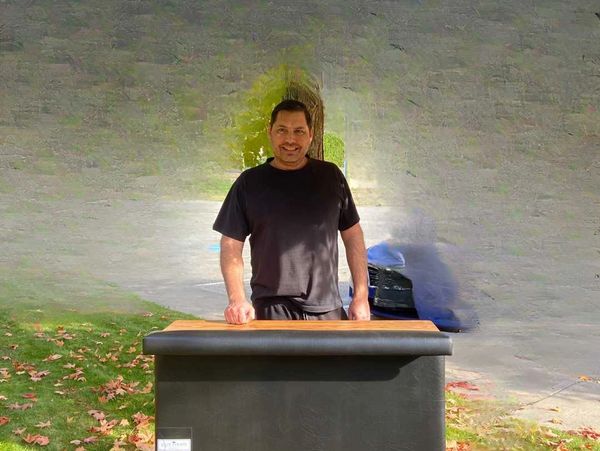 Elite Events BC bartender stands behind a bar, ready to serve drinks. bartending, Parties, Events