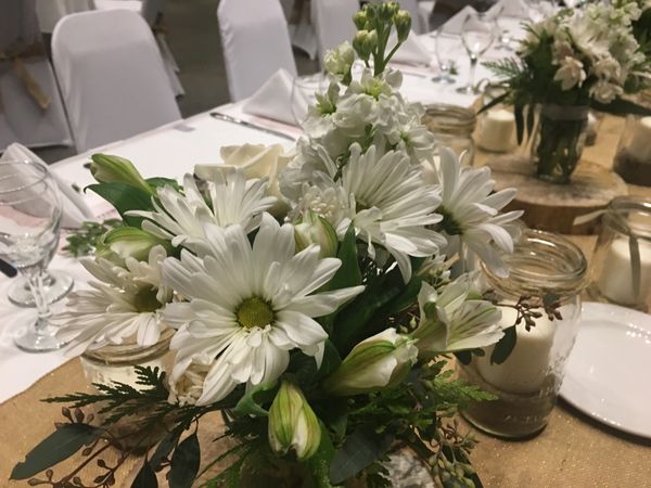 Wedding flower centrepieces with daisies.